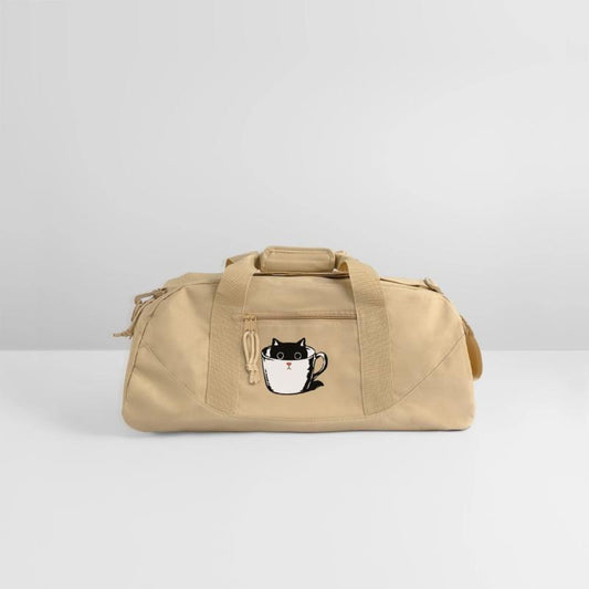 Black kitten with red nose hiding in a cup