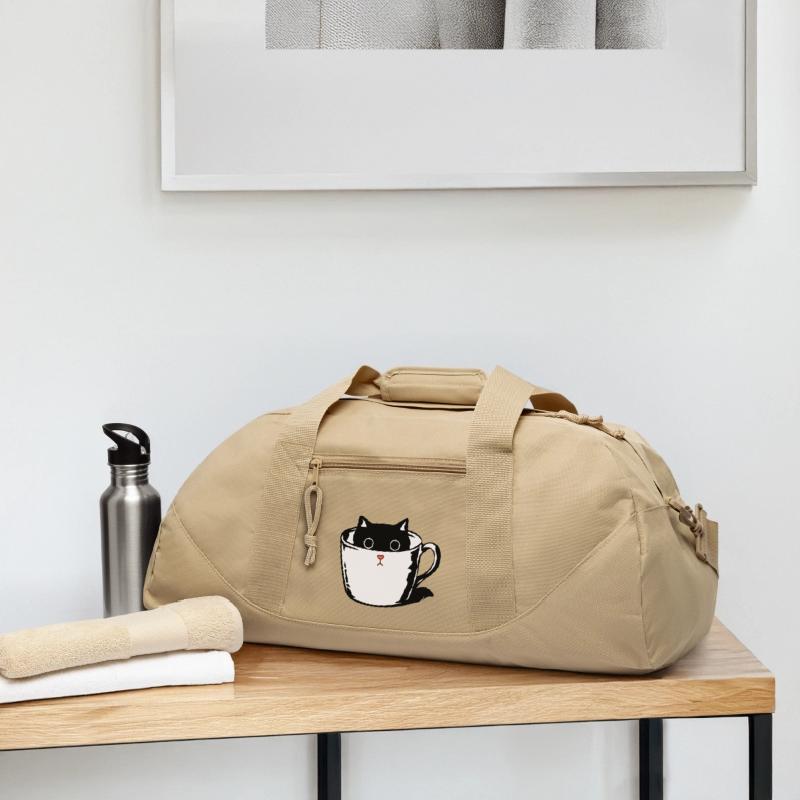 Black kitten with red nose hiding in a cup