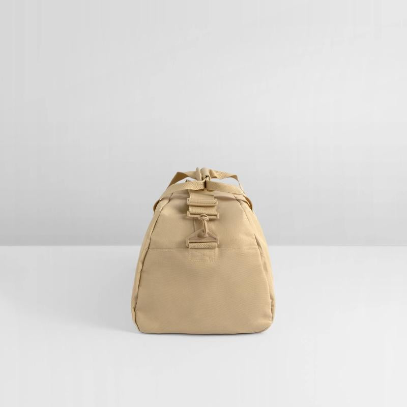 Black kitten with red nose hiding in a cup